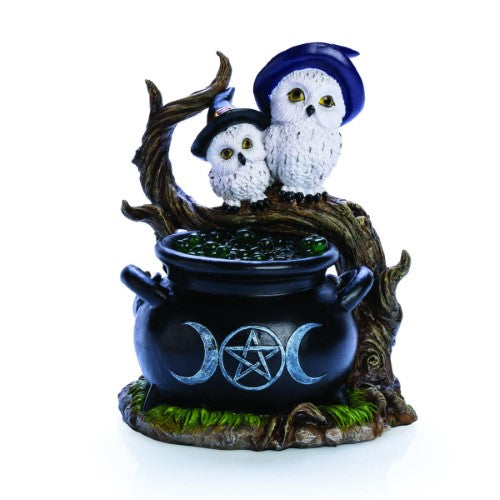 Cauldron-shaped LED light featuring white owls in hats, glowing bubbles, and mystical designs for enchanting ambiance.