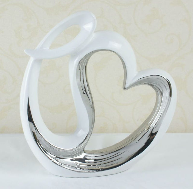 Elegant white and silver heart-shaped ceramic decor, perfect for modern home accents, measuring 7x24x24 cm.