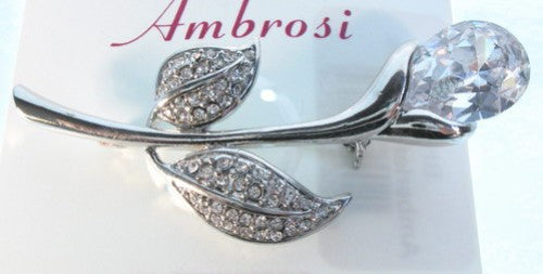 Elegant lily brooch in rhodium plating with shimmering stones, perfect for enhancing any outfit and special occasions.