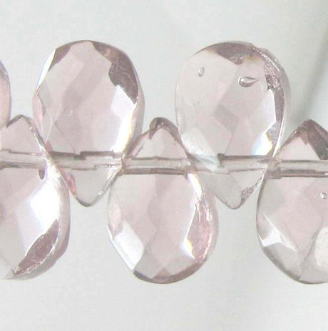 Faceted teardrop beads set of 61, 6x9mm, reflecting light for stunning jewelry and DIY projects.