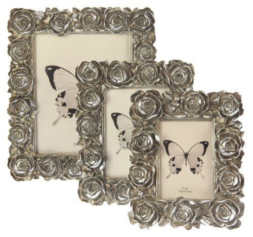 Elegant champagne-colored photo frame with large rose detailing, fitting photos 13 x 18 cm, perfect for displaying cherished memories.