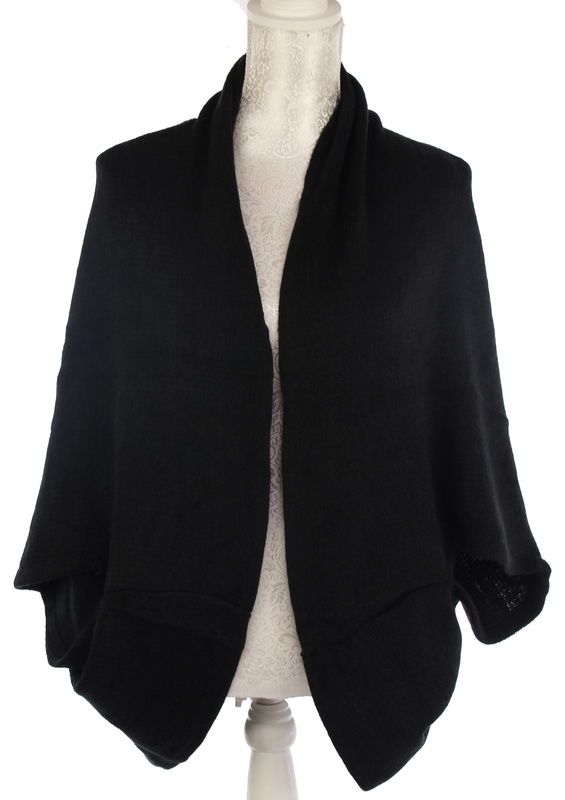 Elegant black dual-use cape transforming effortlessly from shrug to scarf, perfect for style and warmth in any occasion.