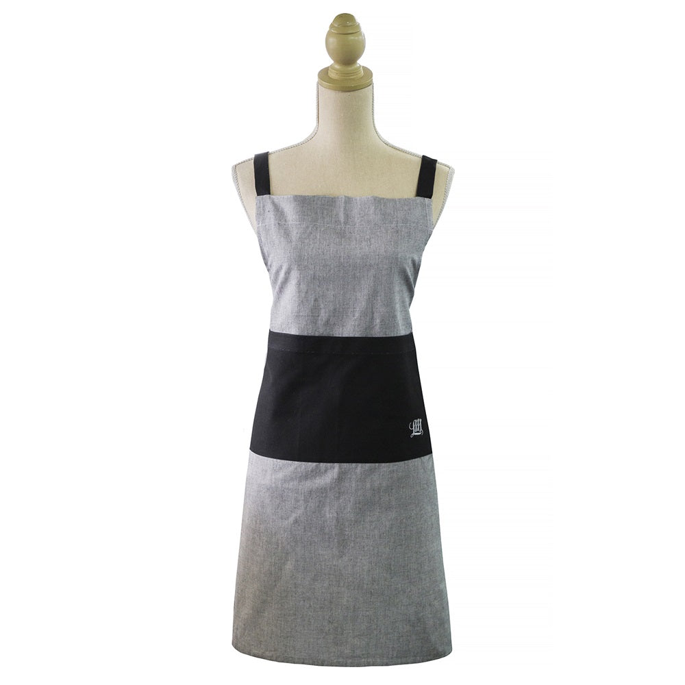 Stylish grey chambray apron with adjustable neck strap and front pockets, perfect for modern home chefs.