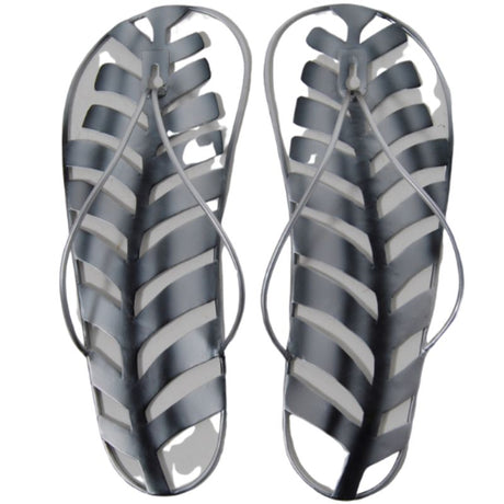 Metal wall hanging featuring a jandal and silver fern, highlighting New Zealand's culture in an elegant 29cm design.