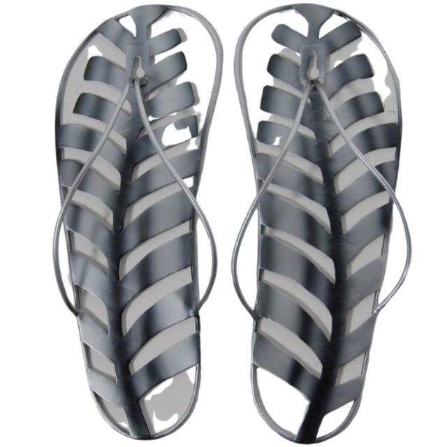Metal wall hanging featuring a jandal and silver fern, highlighting New Zealand's culture in an elegant 29cm design.