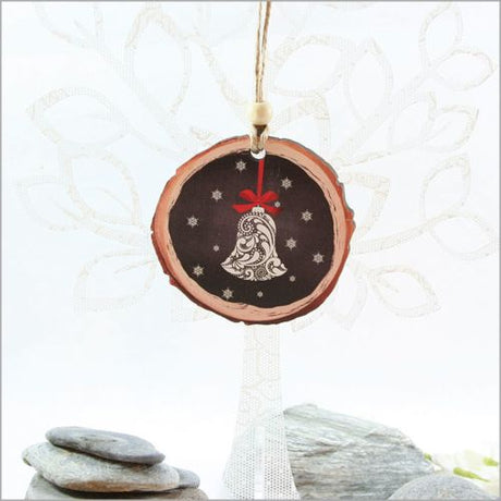 Wood slice ornament featuring a filigree bell design, crafted from durable wood veneer for unique holiday decor.