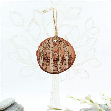 Wood slice ornament featuring intricate bird designs for rustic holiday decor, ideal for gifts and Christmas trees.