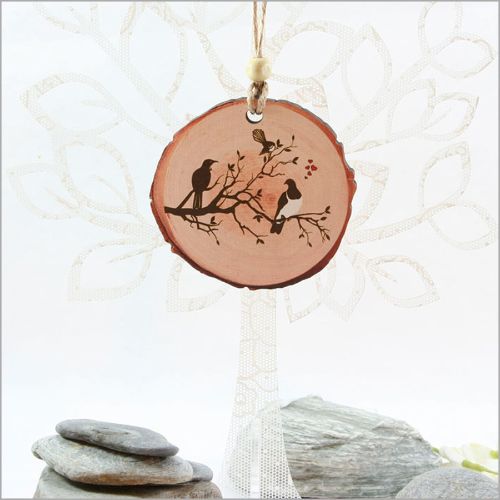 Wood slice ornament featuring laser-cut birds on a tree, perfect for Christmas or year-round display.