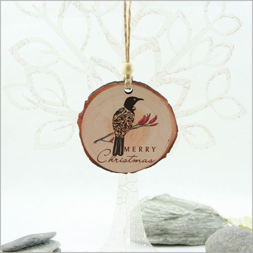 Wood slice ornament featuring a filigree Tui design, perfect for Christmas tree decor and lightweight for easy gifting.