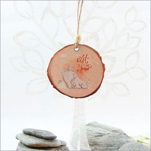 "Laser-cut wood slice ornament featuring 'Let It Snow' design, perfect for Christmas trees and gifting."