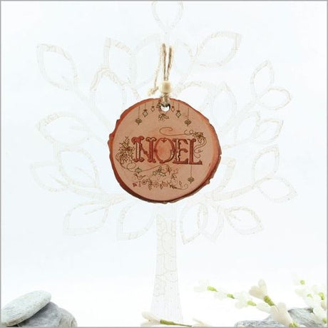 Wood slice ornament featuring "Noel" design, expertly laser cut, perfect for Christmas tree or holiday décor.