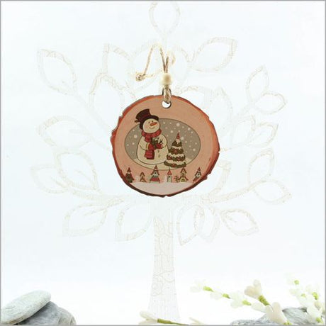 Wood slice ornament featuring a charming snowman scene, perfect for rustic holiday decor or as a thoughtful gift.