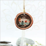 Caravan-shaped wood slice ornament, intricately designed, lightweight, double-sided, perfect for holiday decor and gifting.