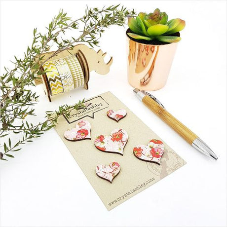Heart-shaped pink floral wall art set featuring five durable MDF pieces, ideal for adding elegance to any room.