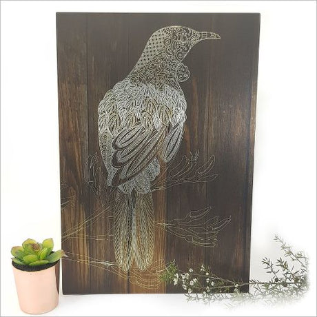 Kiwiana wall art featuring a vibrant Tui bird on dark wood, perfect for enhancing indoor and covered outdoor decor.