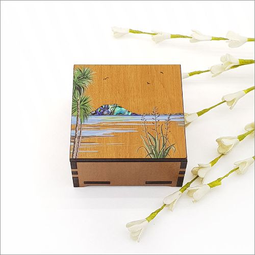 Small square trinket box featuring Mt Maunganui print and inlaid Paua, crafted from NZ Silver Beech veneer.