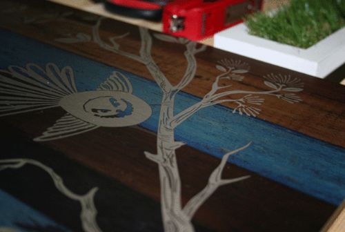 Kiwiana wall art featuring a fantail bird on aged timber, crafted from durable Aluminium Composite, 288mm x 420mm.