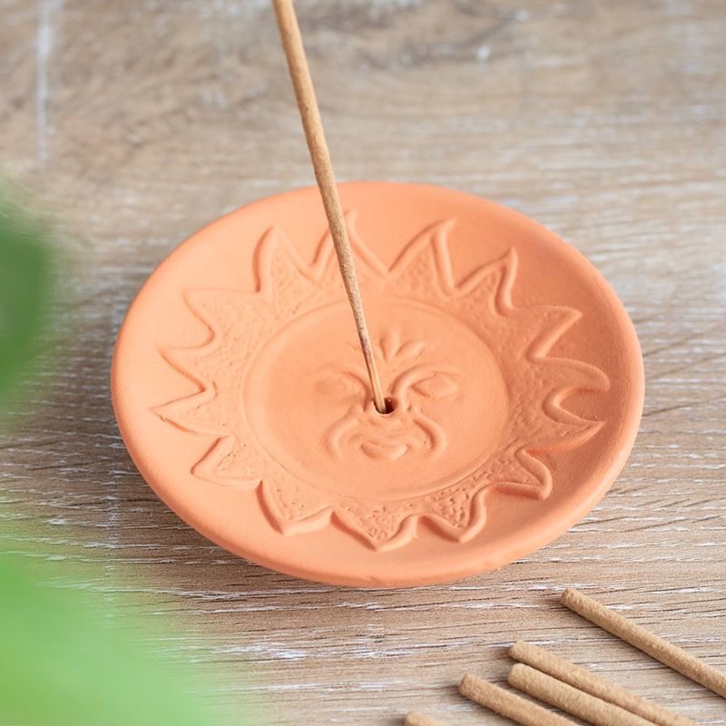 Terracotta incense plate featuring a radiant sun design, ideal for meditation and enhancing your home ambiance.