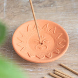 Terracotta incense plate featuring a radiant sun design, ideal for meditation and enhancing your home ambiance.