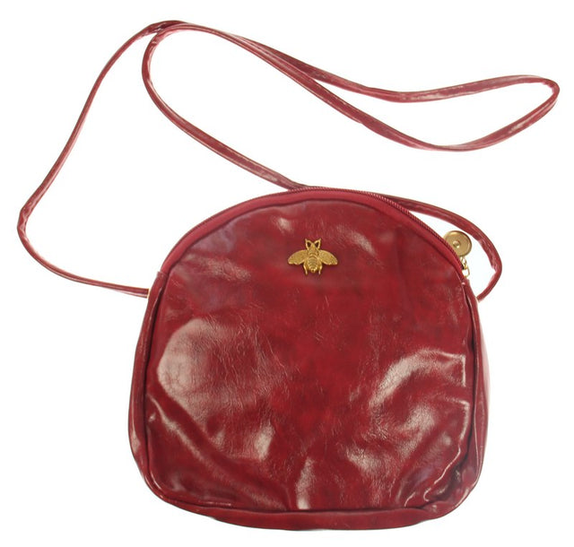 Elegant wine handbag featuring a metal bee front detail and light gold hardware, perfect for any stylish occasion.