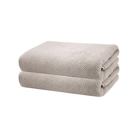 Soft Turkish cotton bath towels in pebble color, 70x140 cm, featuring subtle texture and elegant hem for luxurious comfort.