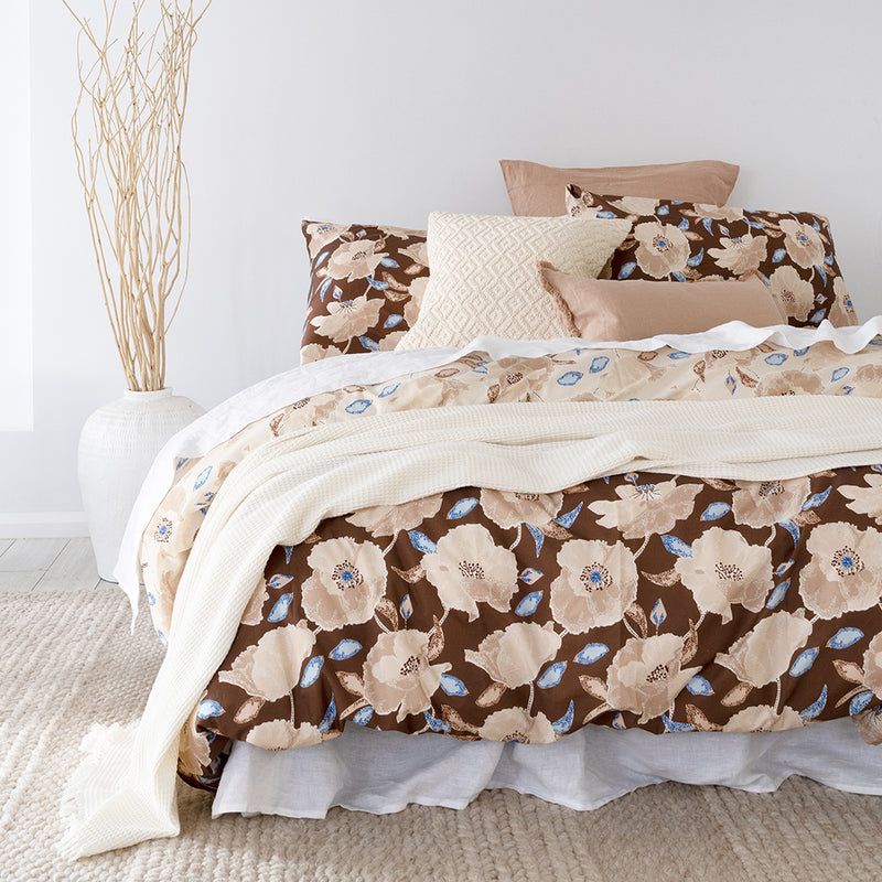 Reversible double duvet cover featuring large poppy flowers, crafted from soft cotton percale in rich chestnut and latte tones.