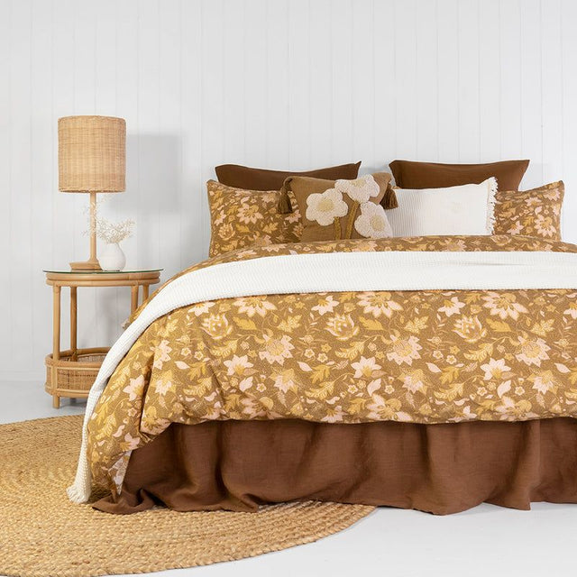 Queen duvet cover set featuring vibrant batik-inspired floral patterns in mustard, olive, and blush on soft enzyme-washed cotton.