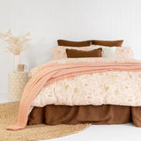 King duvet cover set featuring a serene tropical design in soft peachy pinks and terracotta, crafted from enzyme-washed cotton.