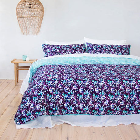 Elegant king duvet cover set featuring vibrant hand-painted floral design in purple, blue, and aqua on luxurious cotton sateen.