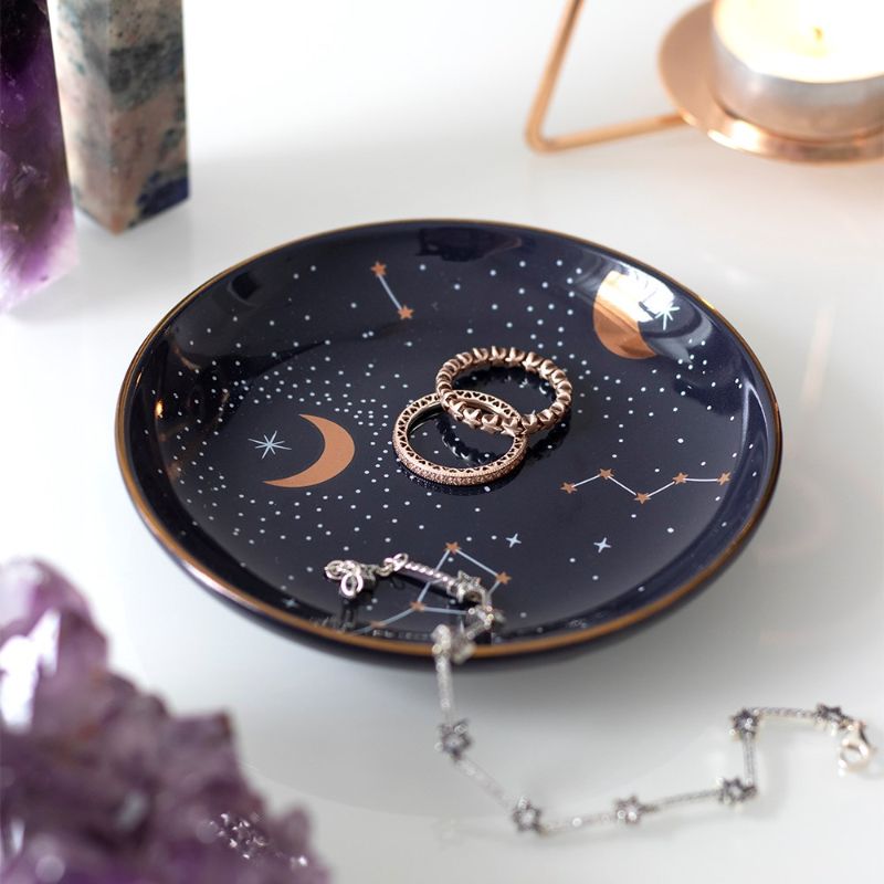 Ceramic purple star sign trinket dish with celestial design, perfect for storing jewelry and small collectibles.