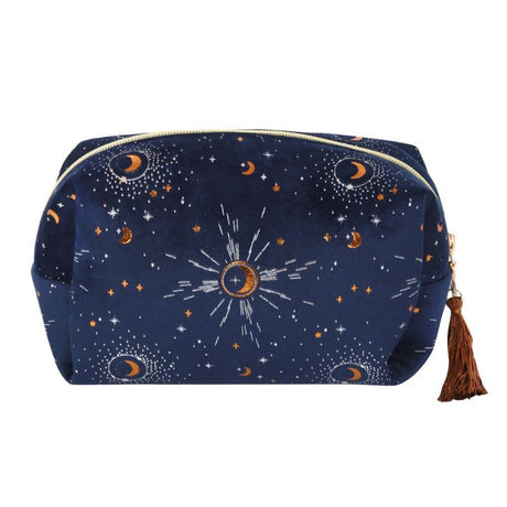 Blue velvet makeup bag with gold crescent moon accents and tassel, perfect for organizing beauty essentials in style.