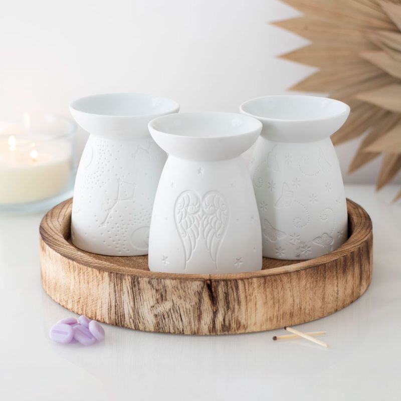 Elegant white ceramic oil burner shaped like a butterfly, perfect for melting wax and infusing spaces with calming scents.