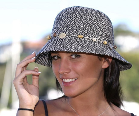 Bohemian bucket sun hat in cotton with UPF 50+, adjustable size, bead and shell trim, perfect for stylish sun protection.