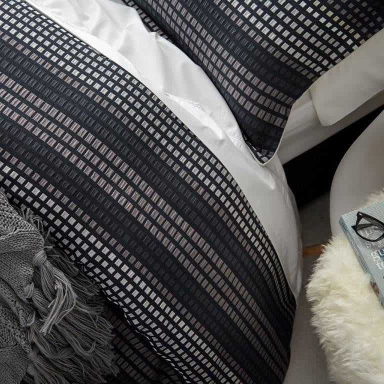 Elegant Benson Navy Queen Duvet Set featuring a pixelated pattern, ivory piping, and soft cotton-polyester blend.