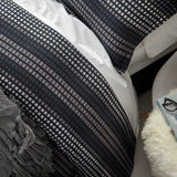 Elegant Benson Navy Queen Duvet Set featuring a pixelated pattern, ivory piping, and soft cotton-polyester blend.