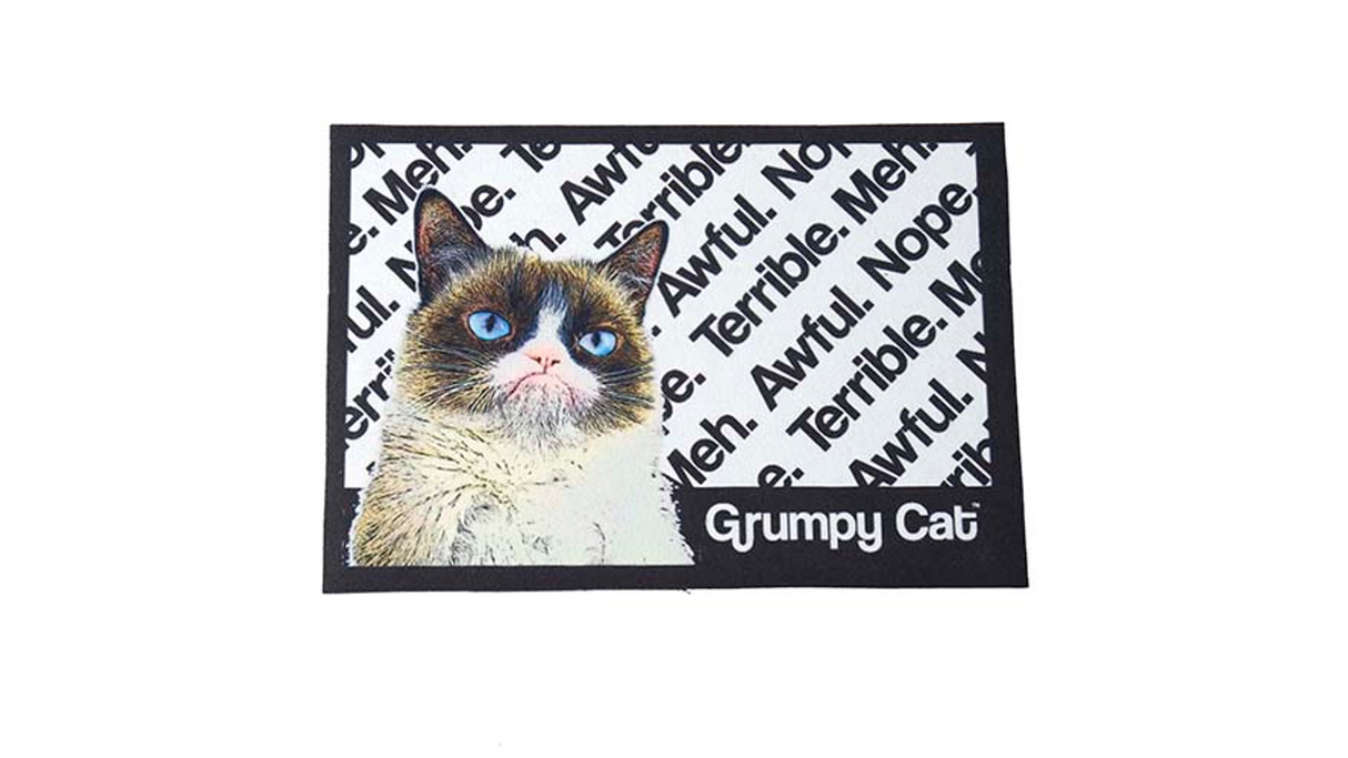 Non-slip plastic placemat featuring Grumpy Cat's image and humorous sayings, measuring 19" x 11.75".