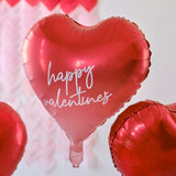 Heart-shaped foil balloons in red and ombré, customizable with stickers, perfect for Valentine's Day celebrations.