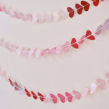 Ombré heart garland in pink to red hues, 5m long, perfect for Valentine's Day celebrations and eco-friendly decor.