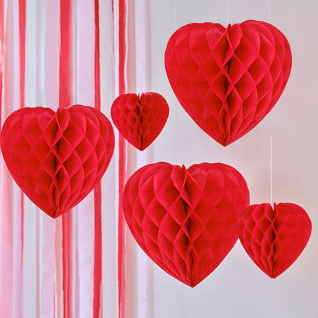 Charming red honeycomb heart decorations in varying sizes for Valentine's Day, crafted from eco-friendly paper.