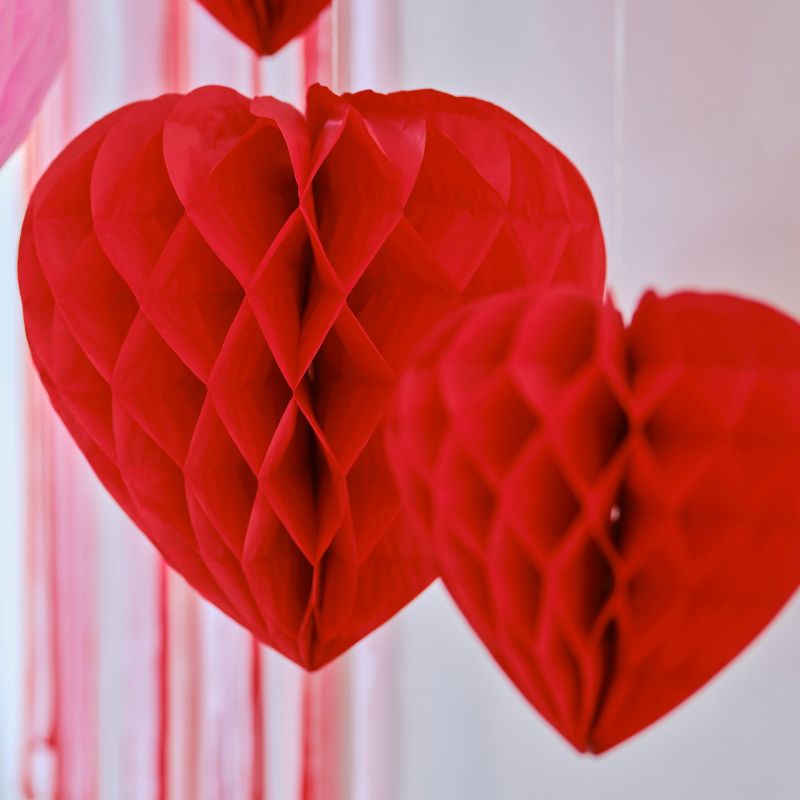 Romantic red honeycomb heart decorations in various sizes, ideal for Valentine's Day and eco-friendly home decor.