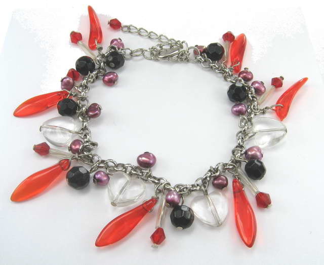 Vibrant red bead and crystal bracelet, perfect for adding a pop of color and elegance to any outfit.