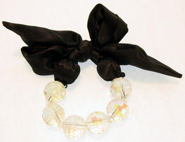 Elegant bracelet featuring large shimmering crystals in a unique ribbon design, perfect for any occasion.