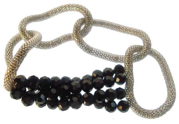 Elegant 4-row black chain link bracelet with large links, rhodium plating, and elastic design for comfort.