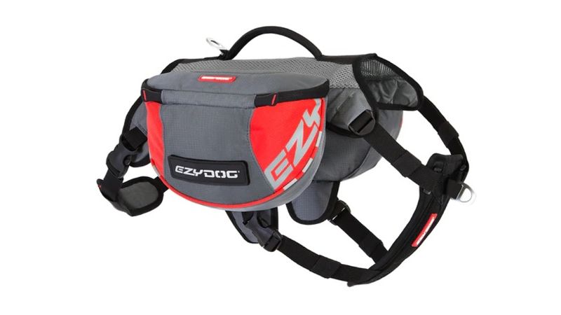 Ergonomic red dog backpack with reflective trim, breathable material, and award-winning harness for outdoor adventures.