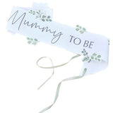 Botanical Baby Mummy to Be sash featuring a floral design and sage green ribbon, perfect for baby showers and maternity celebrations.