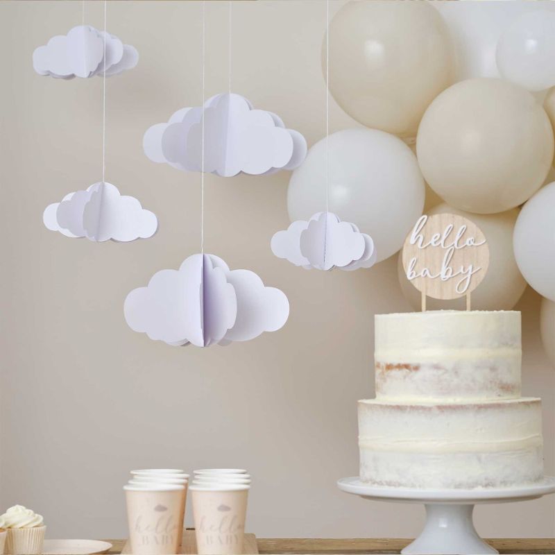 Five white 3D hanging cloud decorations, perfect for nurseries, adding a whimsical touch and airy ambiance.