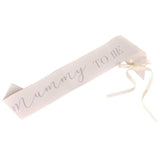 Elegantly designed cream "Mummy to Be" sash, perfect for baby showers, featuring a charming bow and high-quality materials.