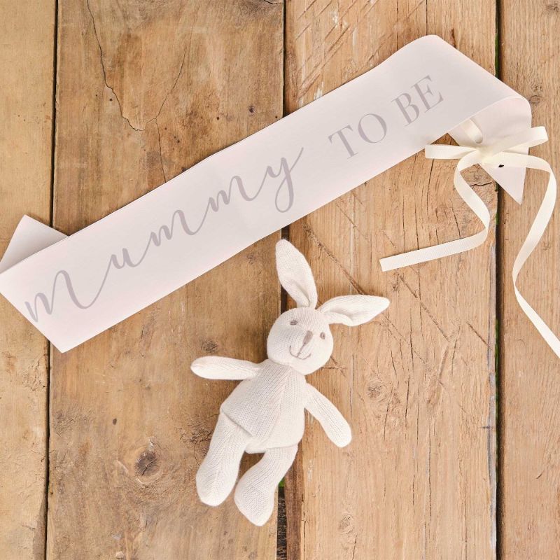 Cream "Mummy to Be" sash with elegant bow, perfect for celebrating pregnancy at baby showers.