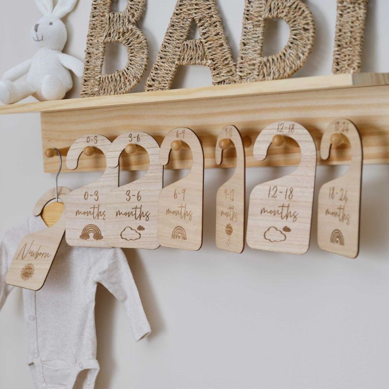 Pack of 7 Hello Baby wooden baby hangers, perfect for organizing infant clothes with a stylish, smooth finish.