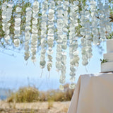 Sage green paper tissue backdrop with 16 strands, perfect for romantic wedding decor and photo opportunities.